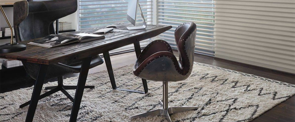Industrial-style office with a decorative rug with diamond patterns